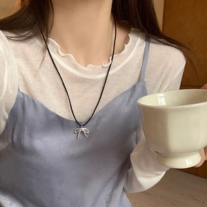 Elegant silver bow pendant on a slim black drawstring choker necklace for women