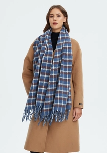 Detail of blue and white tartan scarf with handmade fringe on a wool coat