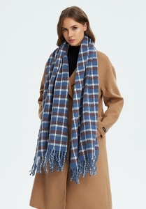 Detailed view of blue plaid scarf with long fringe tassels paired with a camel wool coat