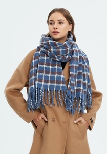 Close-up of blue and grey plaid scarf with soft tassels and thick woven texture