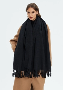 Close-up of the thick faux cashmere texture and elegant fringe tassels on this black scarf