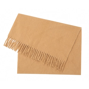 Close-up detail of soft camel knitted scarf with dense decorative fringes for winter