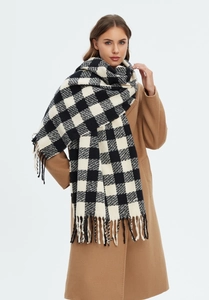 Close-up of black and white checkered scarf featuring soft texture and fringe details