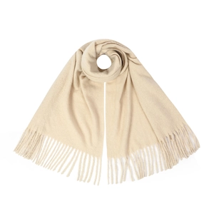 Close-up of cream knit scarf featuring soft texture and decorative long fringe edges