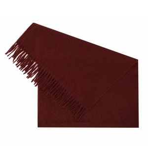 Close-up of burgundy knit scarf with soft texture and long elegant fringe details
