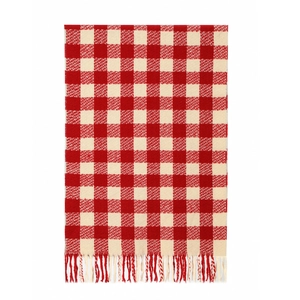 Detailed close-up of soft red and white checkered knit scarf with decorative fringe ends