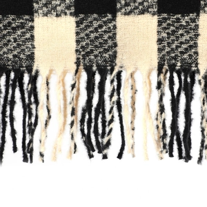 Close-up of black and white checkered scarf featuring soft texture and long tassel fringe
