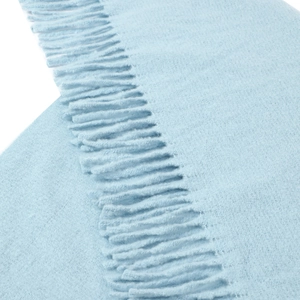Detail of light blue faux cashmere scarf featuring soft texture and fringe tassels