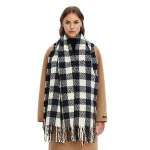 Classic black and white checkered scarf with tassel hem over a camel coat