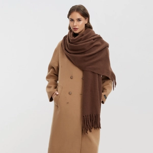 Solid brown cashmere-like scarf with tassels paired with a camel wool coat