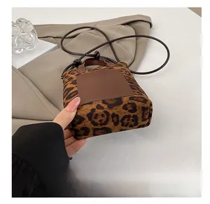 Detail shot showing the flat wear-resistant bottom of leopard print mini crossbody bag