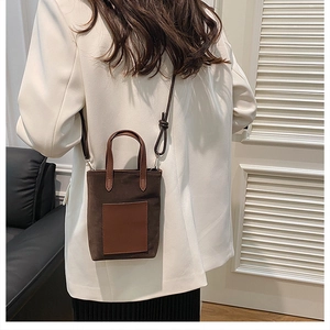 Brown leopard-style mini tote bag shown on a model in a minimalist indoor setting