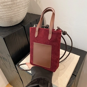 Burgundy faux suede mini bucket bag with leopard print accent and crossbody strap