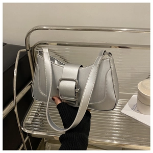 Metallic silver underarm bag with sleek curved design and decorative buckle detail