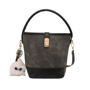 Retro denim and leather bucket handbag with gold twist lock and plush monster charm