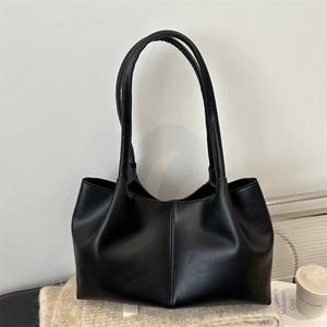 Modern black tote bag with matte PU leather texture and casual slouchy silhouette