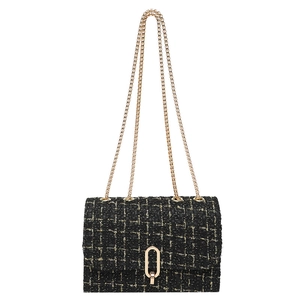 Classic black and gold tweed shoulder bag with a gold chain strap and oval twist lock