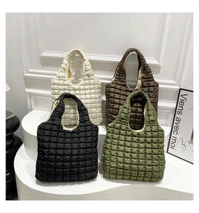 Detailed grid texture on quilted puffer tote bags in beige, black, brown, and olive green
