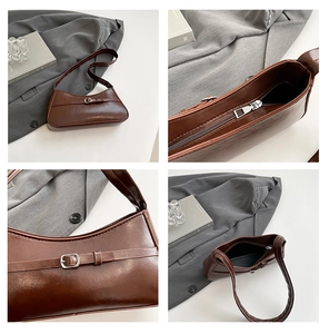 Detail view of coffee brown shoulder bag featuring metallic buckle and zipper closure