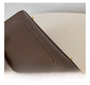 Detail shot of the precise stitching and premium dark brown leather texture of the backpack