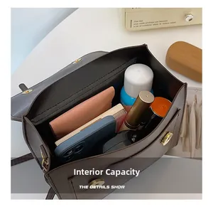 Interior view of brown PU leather backpack showing main compartment and daily essentials
