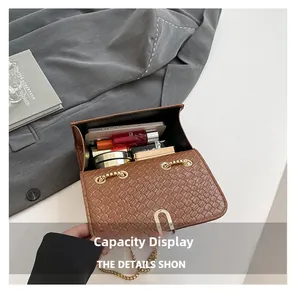 Interior view of brown crocodile texture bag showing phone and cosmetics capacity