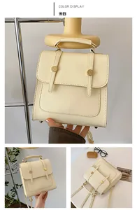 Detailed views of a cream white leather backpack with golden buckles and top handle
