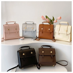 Detailed view of six vintage PU leather backpacks displayed on white platforms