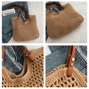 Detail of woven khaki tote with leather handles and gold rivet craftsmanship