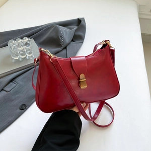 Chic red PU leather underarm bag with gold metal buckle closure and long shoulder strap