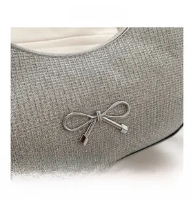 Detailed view of silver glitter texture and decorative metal bow with square pendant