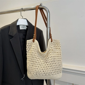 Beige woven straw tote bag with brown PU leather straps for summer beach vacation