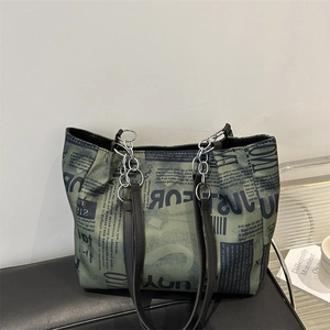 Fashionable large newspaper print tote bag with green and black patterns and chain detail