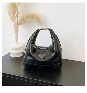 Detail of Moins embossed logo on black faux leather half-moon hobo shoulder bag