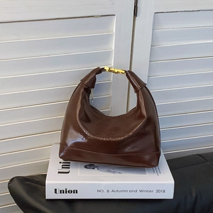 Dark brown minimalist faux leather half-moon shoulder bag with vintage embossed letters