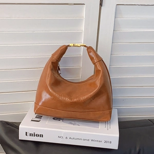 Brown vintage half-moon shoulder bag with embossed letters and gold buckle detail