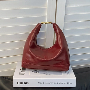 Chic burgundy faux leather shoulder bag with embossed letters and gold metal buckle