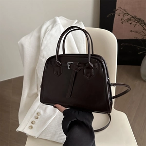 Retro dark brown glossy leather handbag with decorative buckle and detachable strap