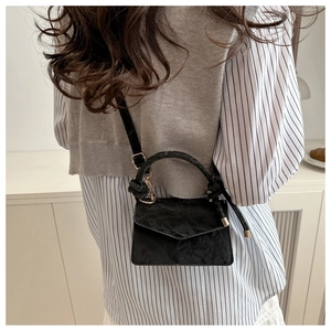 Vue arrière d'un mini sac bandoulière noir texturé avec poignée nouée et finitions dorées