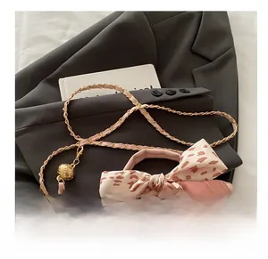 Detail showing the light pink quilted handbag with leopard print silk scarf and chain strap