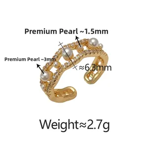 Detailed view of wave-shaped ring with bright pearls and sparkling pave zircon insets