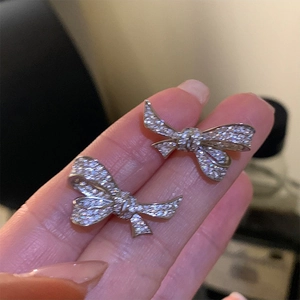 Sparkling zircon silver bow earrings featuring luxury ribbon design and micro-pave crystals