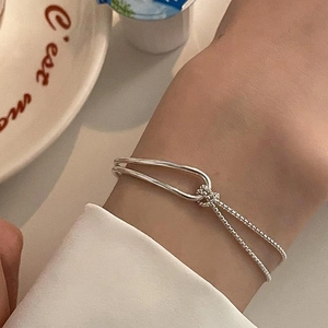 Minimalist double-layer silver knot bracelet with sleek metal band and box chain