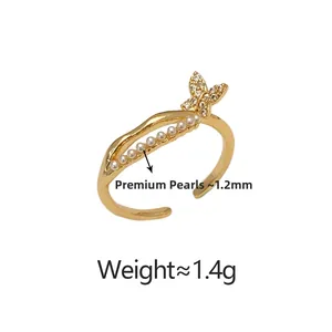 Detailed view of the 1.2mm lustrous pearls and butterfly motif on the gold-tone ring
