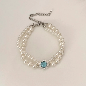 Détail du bracelet perles double rang avec pierre oeil de chat bleue et fermoir argenté
