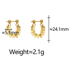 Close-up of gold U-shaped earrings with layered hexagonal sequins and size dimensions