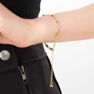 Double-layered 18K gold plated snake chain necklace with elegant square pendant on wrist
