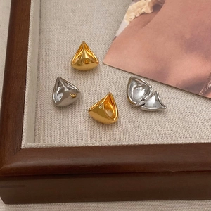 Geometric triangle earrings in gold and silver finish displayed on a linen tray