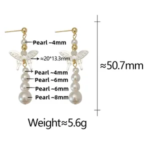 Detail view of butterfly shell earring with gradient pearls and gold metal accents