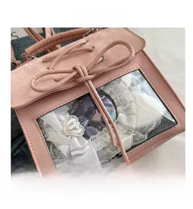 Detailed view of pink Ita bag featuring transparent PVC window and decorative interior